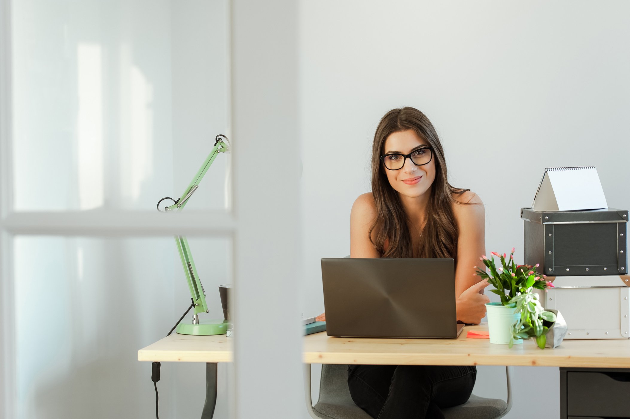 Woman working from home sitting at desk